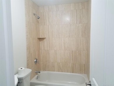 Bathroom with toilet and shower / washtub combination