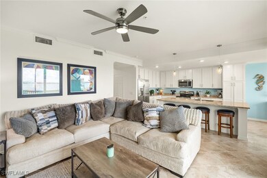 Living room featuring ceiling fan, crown molding,