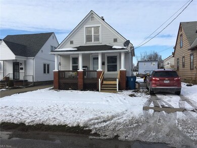 Front of Home.  Partially paved driveway.  Stone h