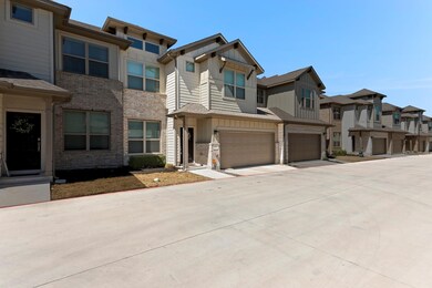 View of front facade featuring driveway, an attac