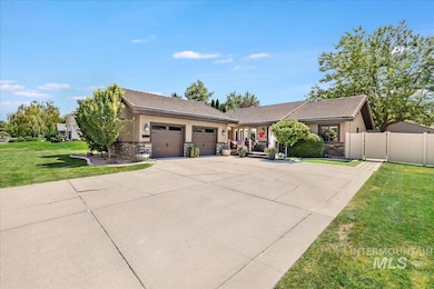 View of front of property featuring stone siding, a garage, driveway, stucco siding, and a tiled roof