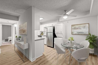 Kitchen featuring white cabinetry, stainless steel