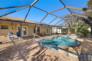 View of pool with glass enclosure, a patio, and fr