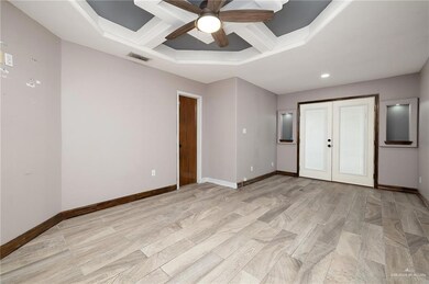 Unfurnished bedroom with visible vents, ceiling fan, baseboards, light wood-type flooring, and french doors