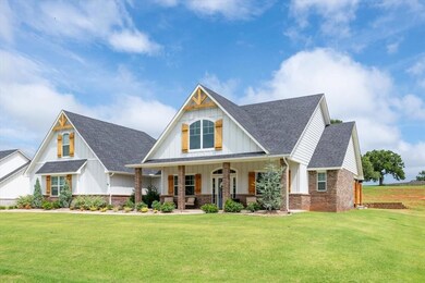 View of front of home featuring a front yard, boar