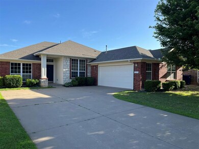 Single story home featuring a garage and a front l
