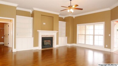 This large family room offers the space and the features you were looking for. Crown molding, recess can lights, built ins, fireplace, laminate hardwood floors, ceiling fan & smooth ceilings