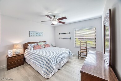 Bedroom with a ceiling fan and baseboards