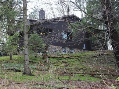 Exterior Front. View from below shows off rock-sid