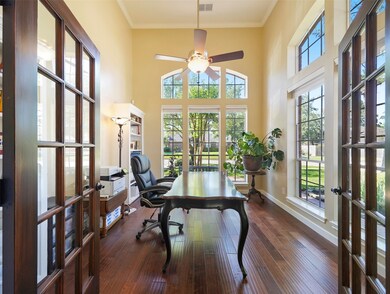 French doors to study show high ceiling, wood floors and lots of light.