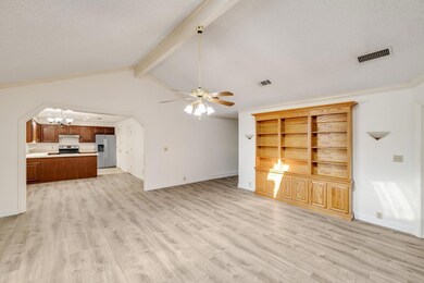 Lliving room featuring vaulted ceiling with beams,