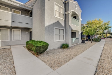 View of side of home featuring stucco siding and a balcony