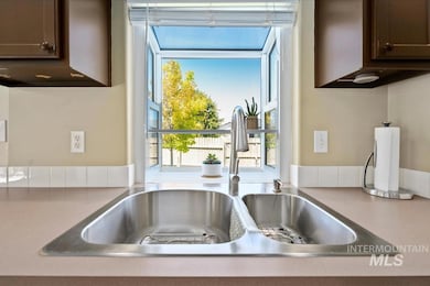 Kitchen view of dark brown cabinets and light countertops