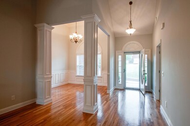 The spacious foyer opens to the formal dining room and living room