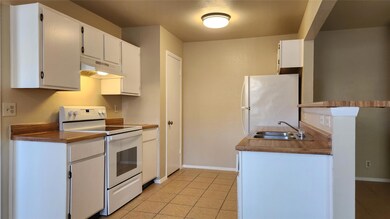 Kitchen featuring white appliances, under cabinet