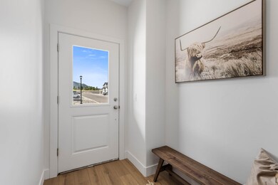 Doorway to outside featuring wood finished floors and baseboards