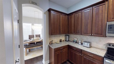 West portion of kitchen and view into dining room