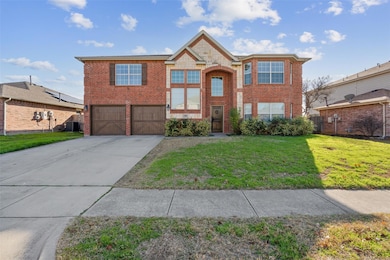 View of front of home with a front yard and a gara