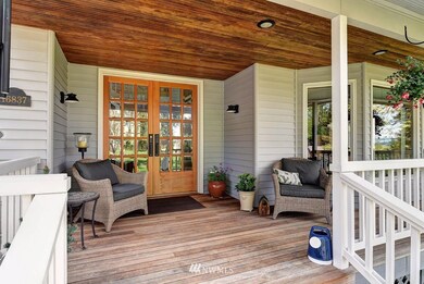 Country style front porch with stunning french doors welcoming you into the open foyer!