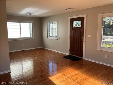 Foyer entrance with baseboards and wood finished floors