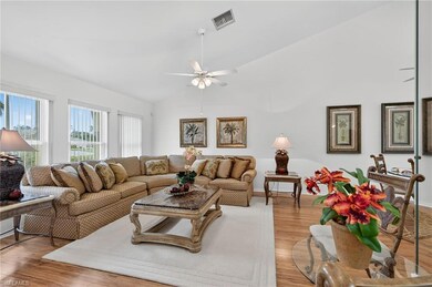 Living room with vaulted ceiling, wood finished floors, and ceiling fan