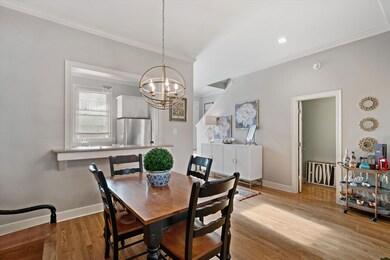 Dining space with baseboards, an inviting chandeli