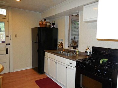 Kitchen. The laminate flooring continues into the 