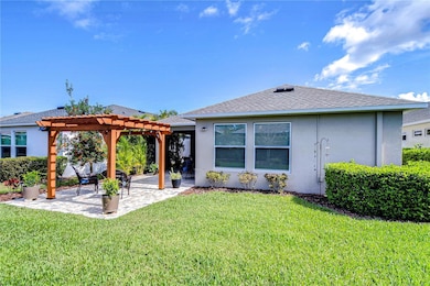 This charming backyard oasis invites you to unwind under a stylish pergola, perfect for morning coffee or sunset chats.