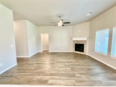 Unfurnished living room featuring ceiling fan, a s