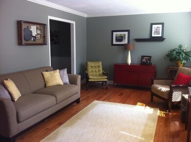 Beautiful new hardwood floors in this formal living room with crown molding and large baseboards, what's not to love? 