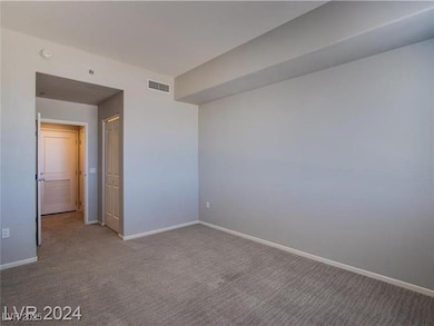 Carpeted spare room with baseboards