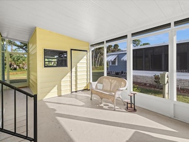 THE LANAI HAS NEW SCREENS AND DOUBLE DOORS FOR EASY ACCESS TO THE STORAGE BUILDING WITH WASHER AND DRYER HOOKUPS.