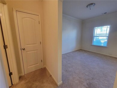 Spare room featuring ornamental molding, baseboard