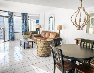 Dining room with light tile patterned floors, a te