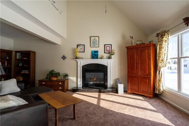 Family room with vaulted ceiling features a gas fi