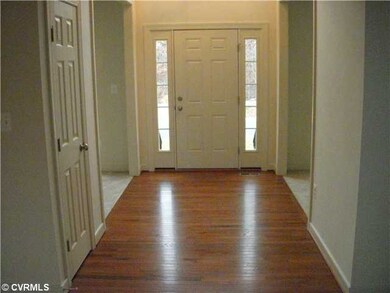 Foyer - Sidelights, hardwood flooring, large chand