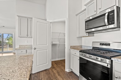 Kitchen featuring dark wood-style floors, visible 