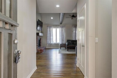 Corridor with beam ceiling and dark hardwood / woo