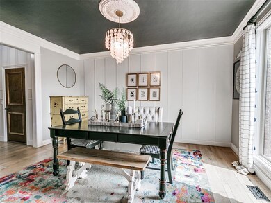Dining area with an inviting chandelier, crown mol