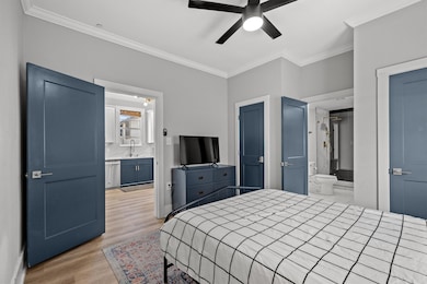 The bedroom features crown molding and double clos