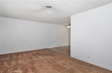 Living room opens to the dining and kitchen