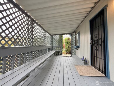 Covered front porch with security screen doors on both the front and back.