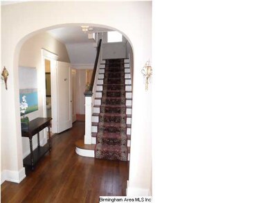 Large open foyer with archways to living room and 