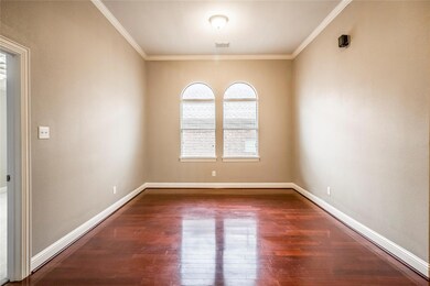 Unfurnished room with dark wood-type flooring and ornamental molding