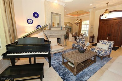 Living area with crown molding, a chandelier, and