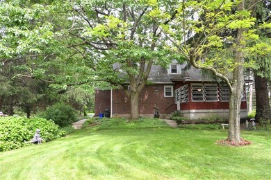 VIEW OF BACK OF HOME WITH SUNPORCH.
