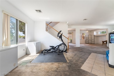 Exercise room with carpet floors, plenty of natura