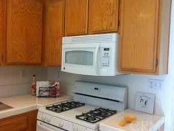 Newer appliances include gas stove and microwave h