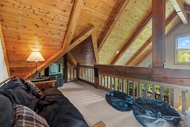 Carpeted living area with wooden ceiling