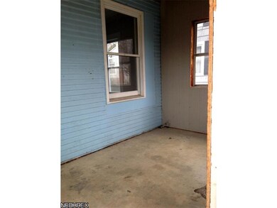 Enclosed front porch could be used as a three seas